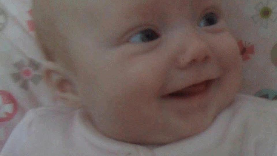 Close up of baby Jessie, smiling.