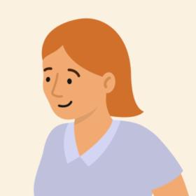 Lady with orange hair and a blue top, smiling.