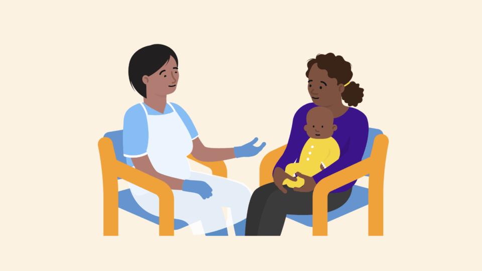 A health professional sitting on a chair, opposite a mum sitting on a chair with her baby on her lap, having a conversation.