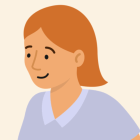 Lady with orange hair and a blue top, smiling.