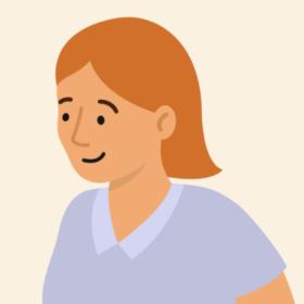 Lady with orange hair and a blue top, smiling.