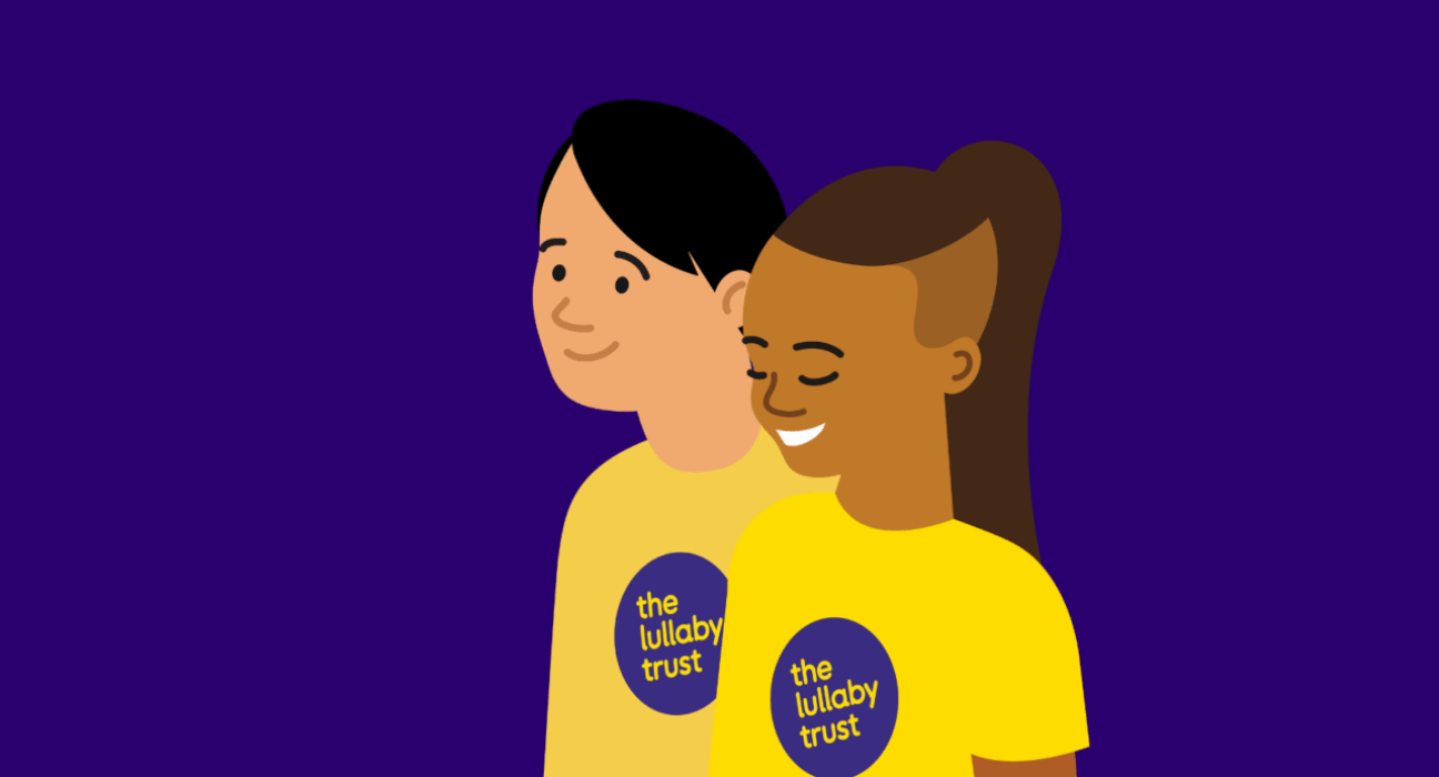 Illustration of two people wearing Lullaby Trust t-shirts. One has medium-dark skin, and the other fair. They are both smiling.
