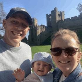 Mark taking a selfie, smiling at the camera on a sunny day with his fiancee May and his son Malyn.