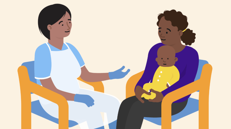 A health professional sitting on a chair, opposite a mum sitting on a chair with her baby on her lap, having a conversation.