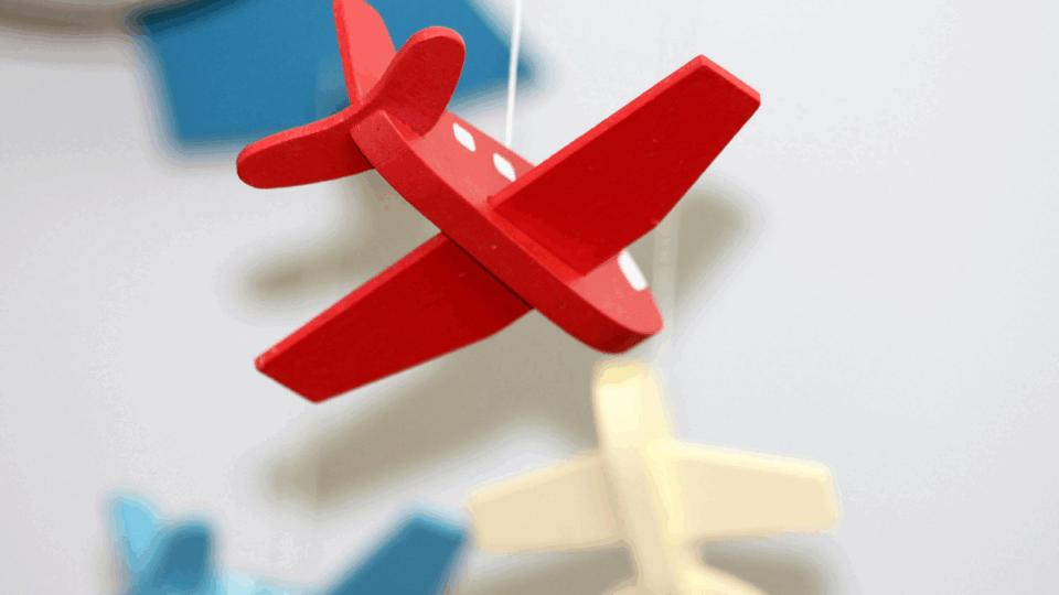 Mobile of airplanes hanging in a baby's bedroom.