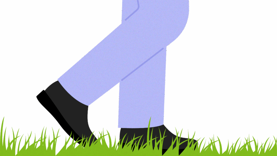 Man's feet walking on some grass
