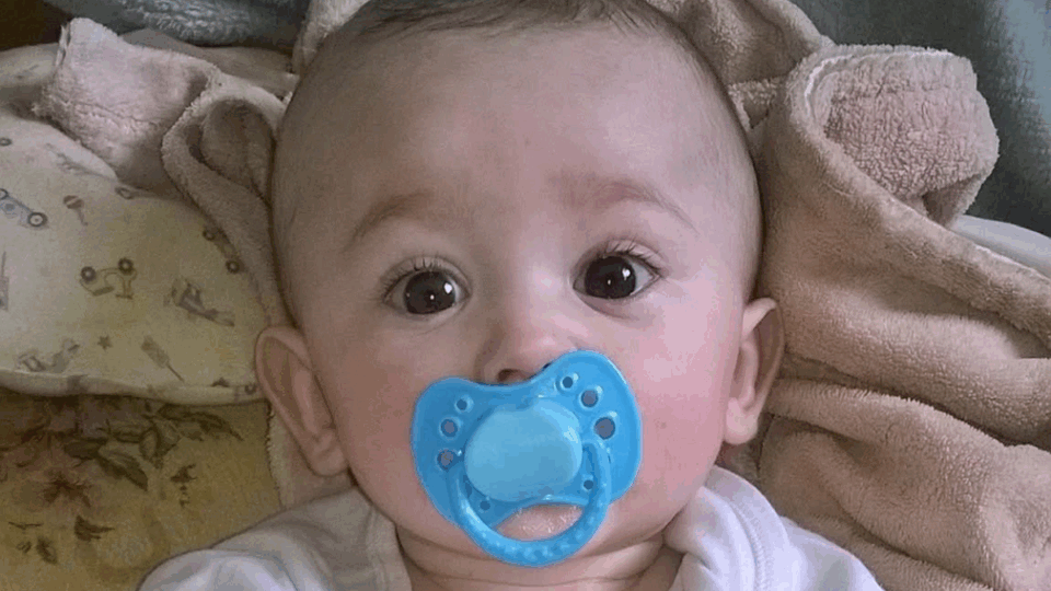 Baby Freddie with a dummy in his mouth