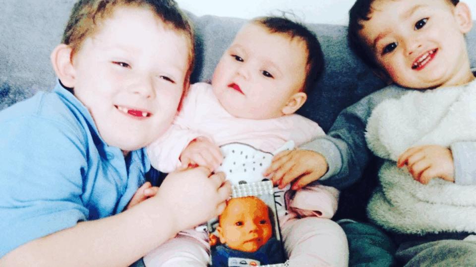 Paige's children, and holding up a photo of baby Harrison.