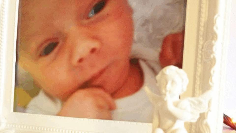 Baby Harrison's photo in a white frame