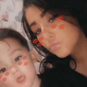 Paige and her son Freddie, with a snapchat filter on their face making at look as though they have lipstick marks on them.