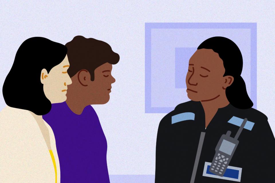 Policewoman in uniform talking to parents in their home.