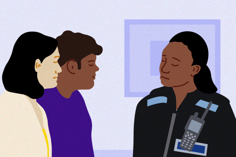 Policewoman in uniform talking to parents in their home.