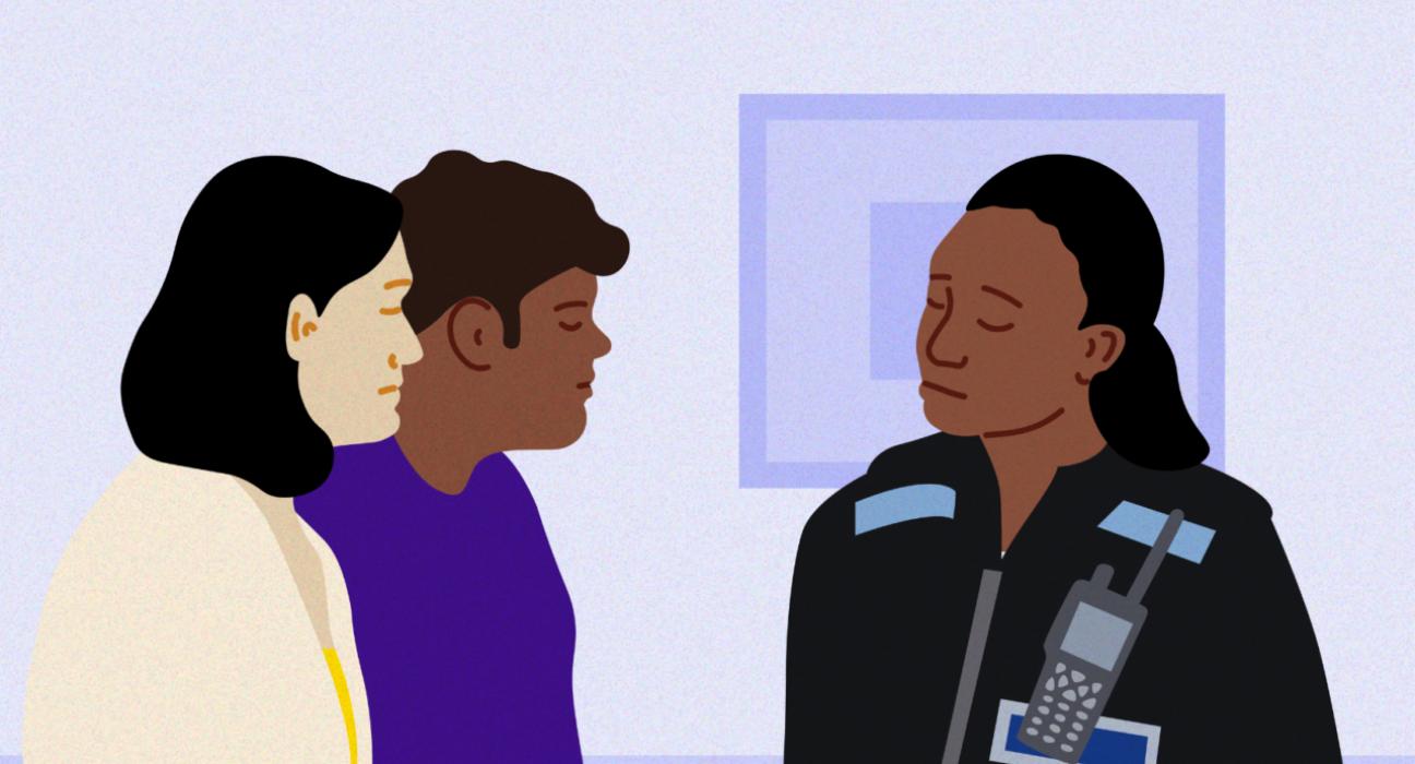 Policewoman in uniform talking to parents in their home.