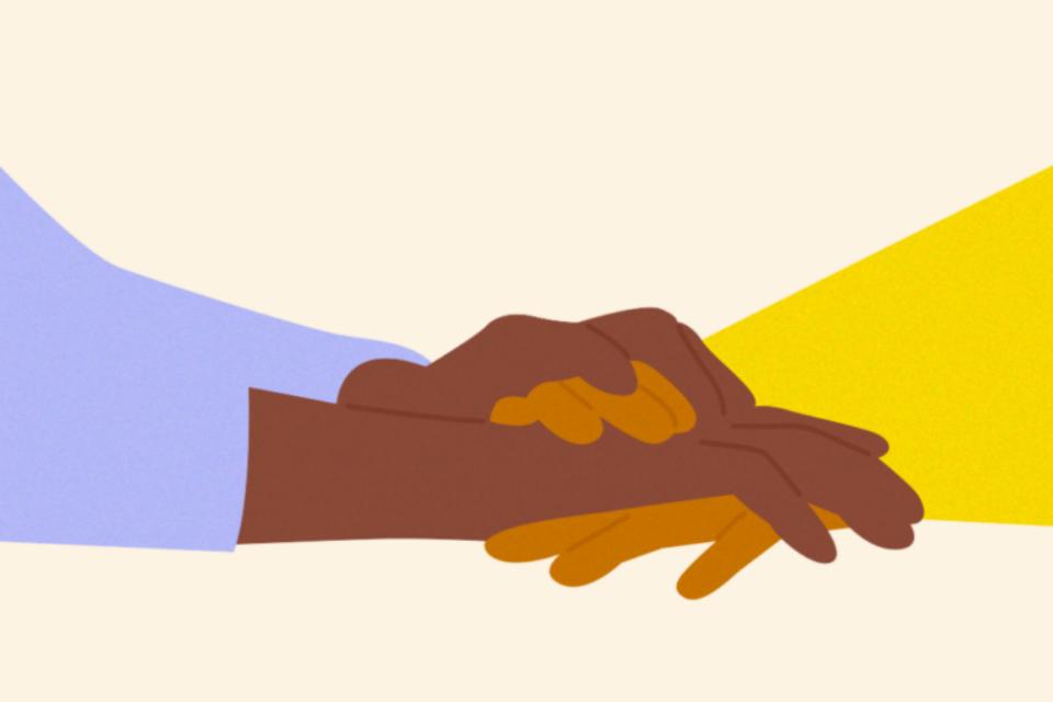 Close up of holding hands in support.