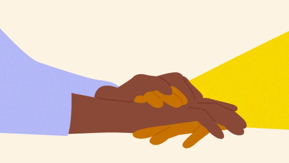 Close up of holding hands in support.