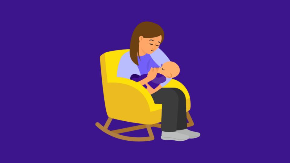 Lady in yellow armchair holding a baby looking concerned.