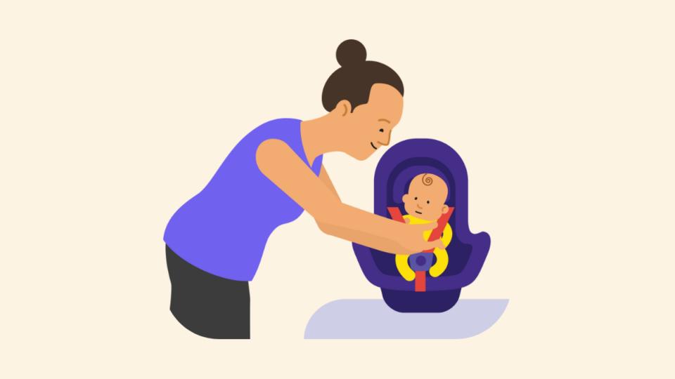 Lady wearing purple, strapping baby into a carseat