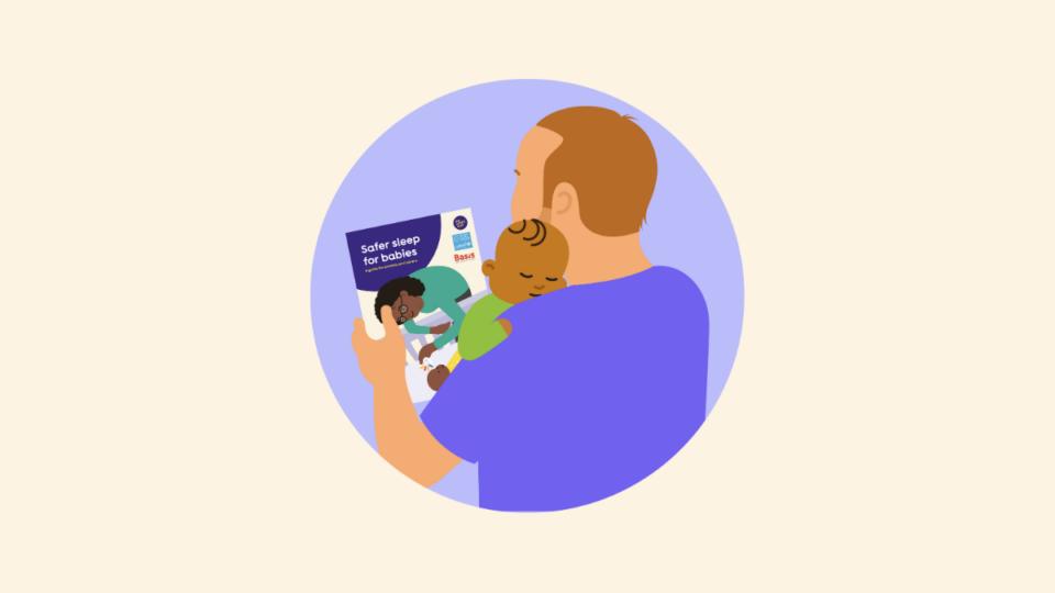 Man holding a baby, and reading The Lullaby Trust's guidance