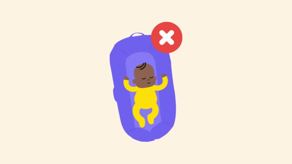 Baby wearing a yellow babygrow in a purple pod. There is a red cross next to it.