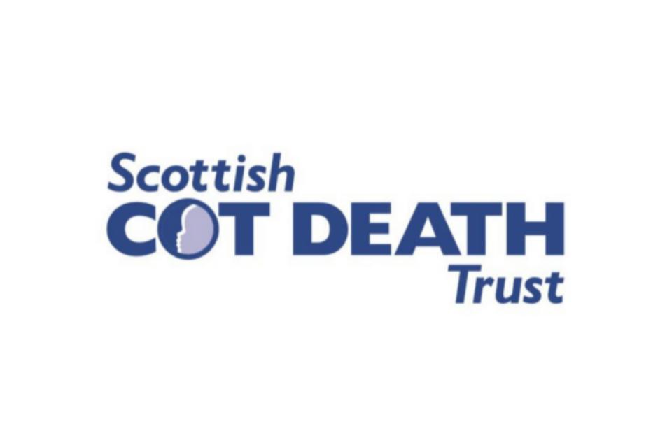 The Scottish Cot Death Trust logo. Blue font on a white background, in the O of Cot death, is the outline of a baby's face.