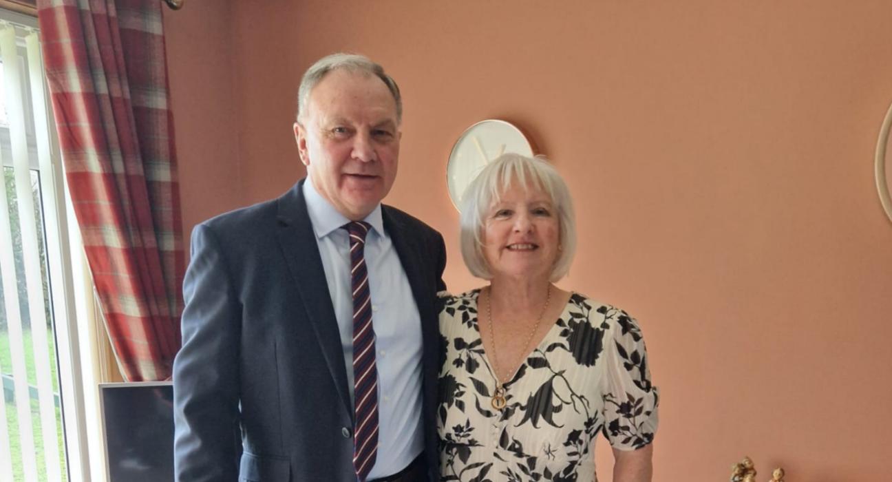 Marjorie and Ian, standing beside each other smiling at the camera