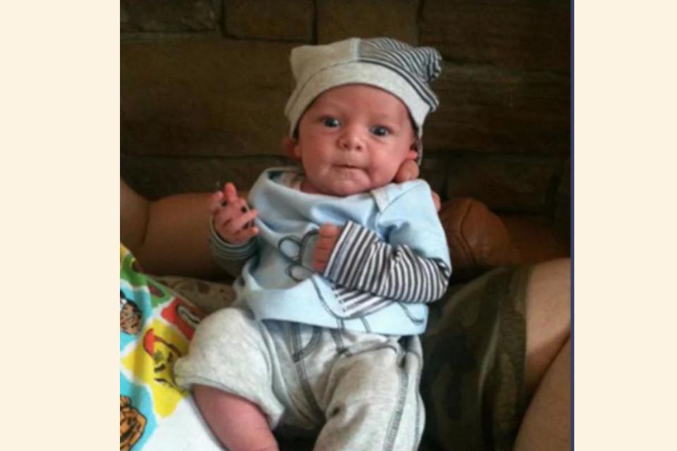 Baby Olli wearing stripy hat