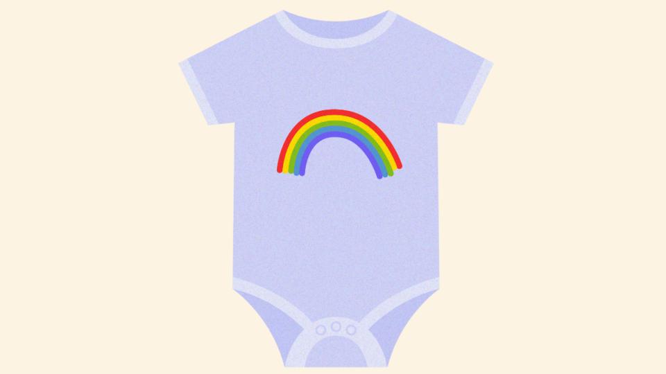 A babygrow with a rainbow on it.
