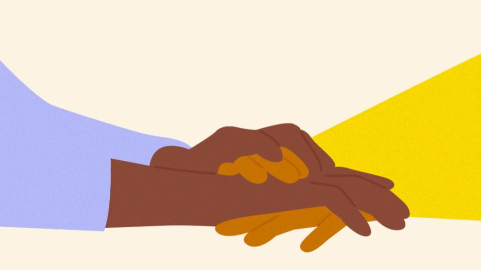 Close up of holding hands in support.