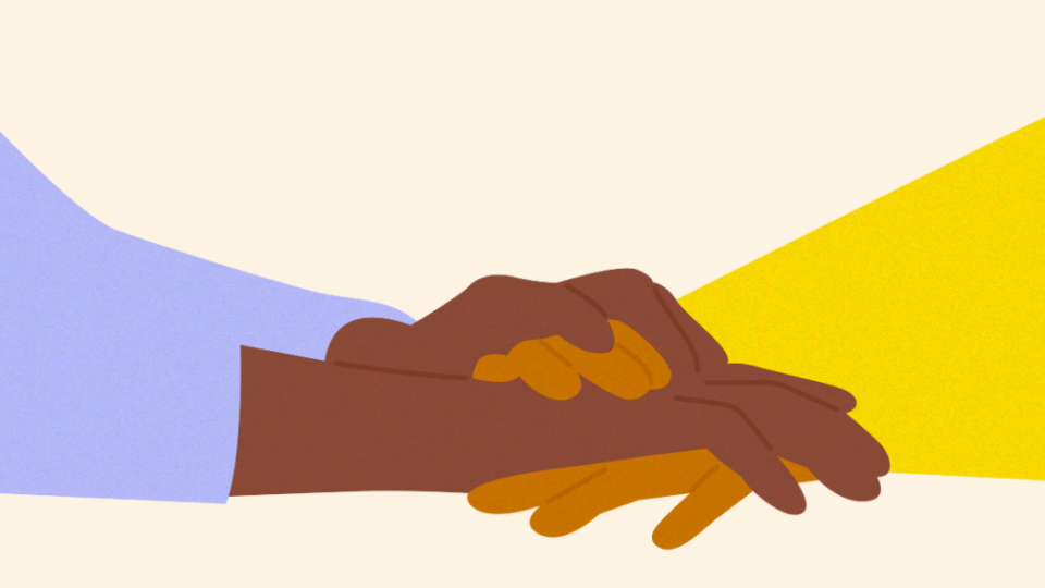 Close up of holding hands in support.