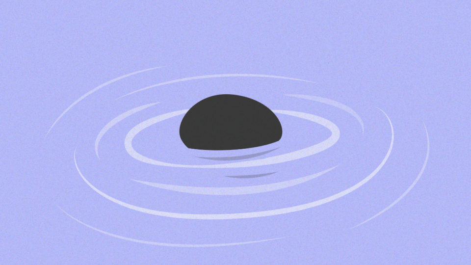 Pebble in water with ripples radiating outwards.