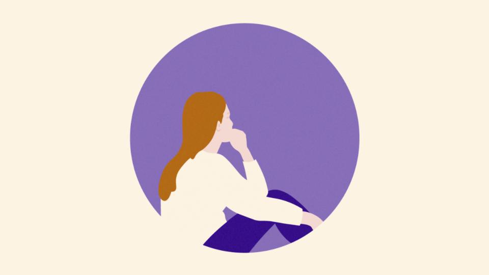 Lady sitting on the floor facing backwards with her chin resting on her hand.