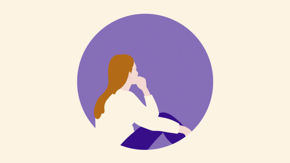 Lady sitting on the floor facing backwards with her chin resting on her hand.