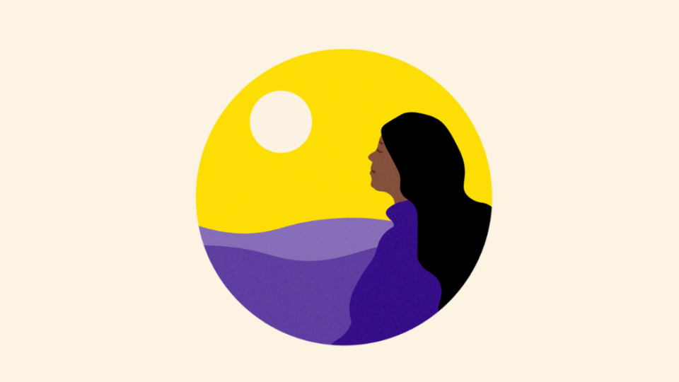 Lady looking behind her at a sunset over a landscape.