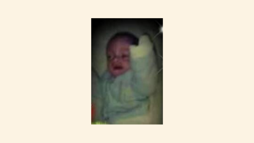 Baby Brian, lying down, awake.