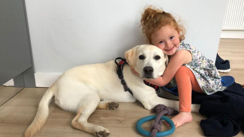 Amy cuddling her dog, Jasper.