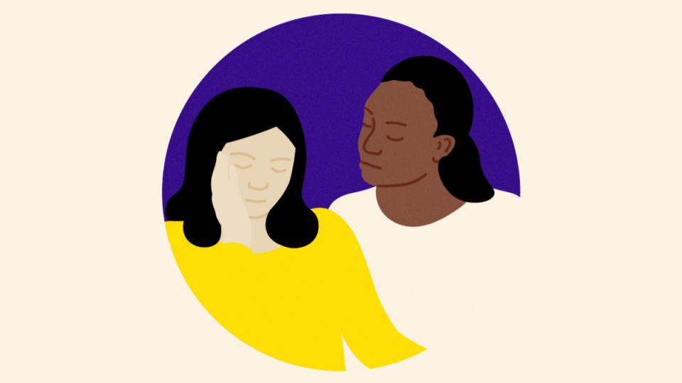 Lady sitting beside another person in support.