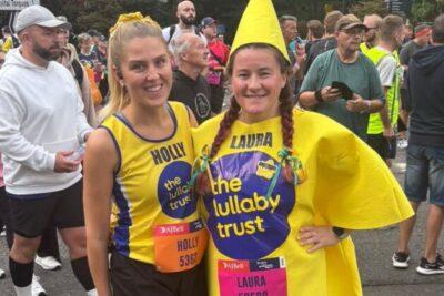 Two female runners in Lullaby yellow. One dressed as a star