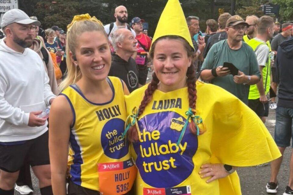 Two female runners in Lullaby yellow. One dressed as a star