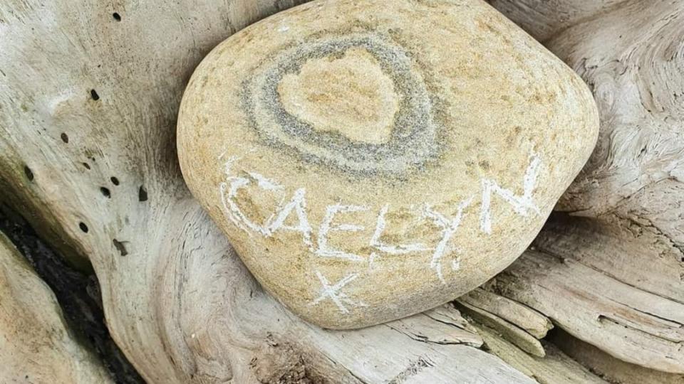 Caelyn's name etched into a stone.