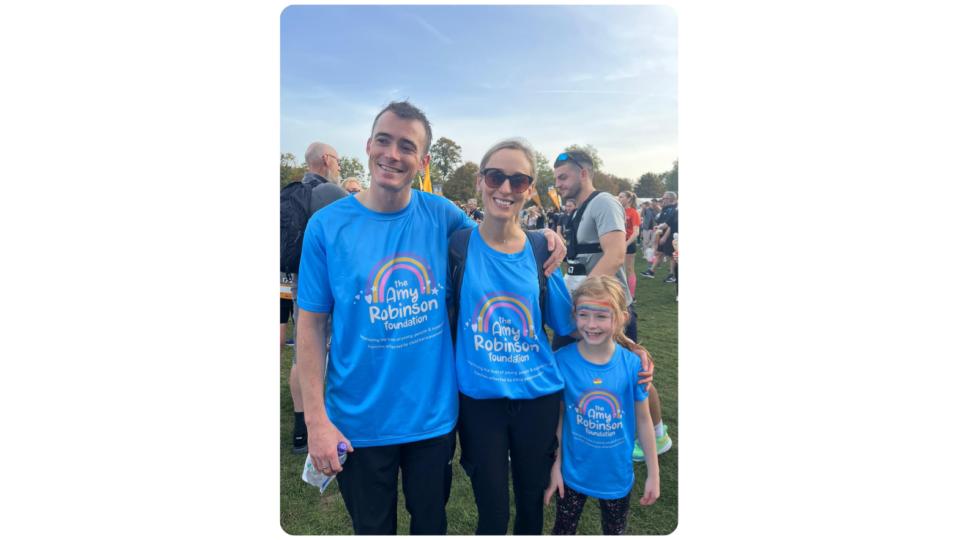 Laura and her family wearing blue Amy Robinson Foundation t-shirts