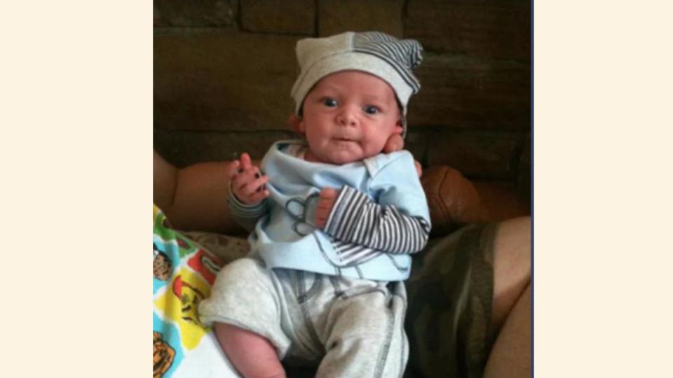 Baby Olli wearing stripy hat