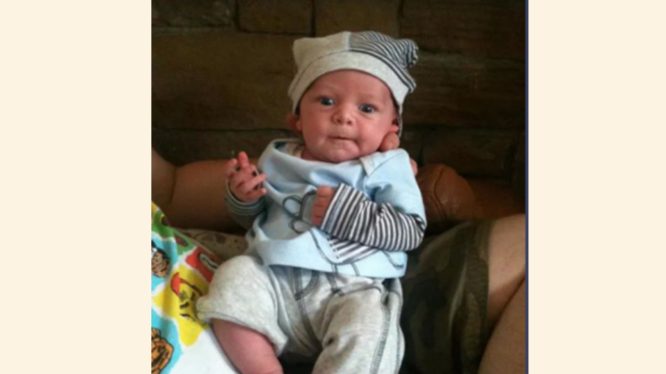 Baby Olli wearing stripy hat