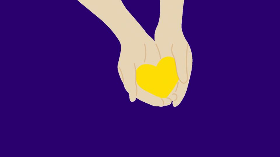 Hands holding yellow heart on purple background.