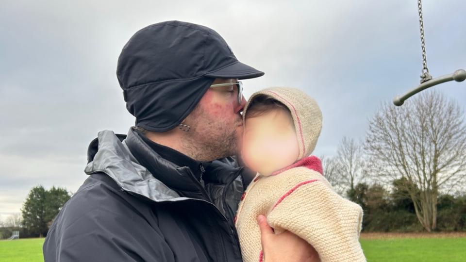 Murihah's husband giving Alannah a kiss on the cheek.