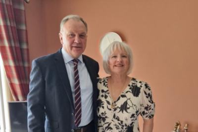 Marjorie and Ian, standing beside each other smiling at the camera