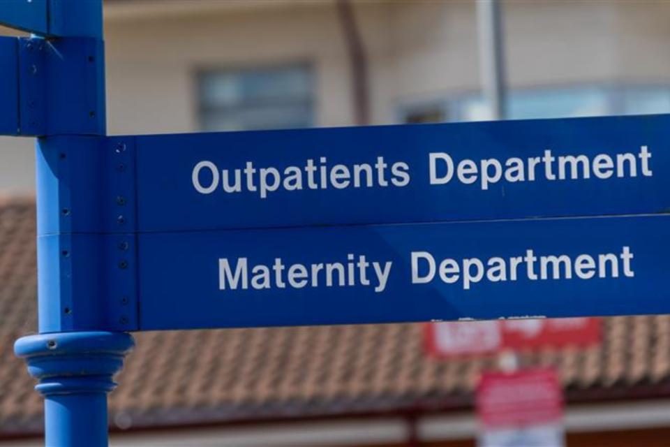Hospital signs saying 'Outpatients department' and 'Maternity department'.