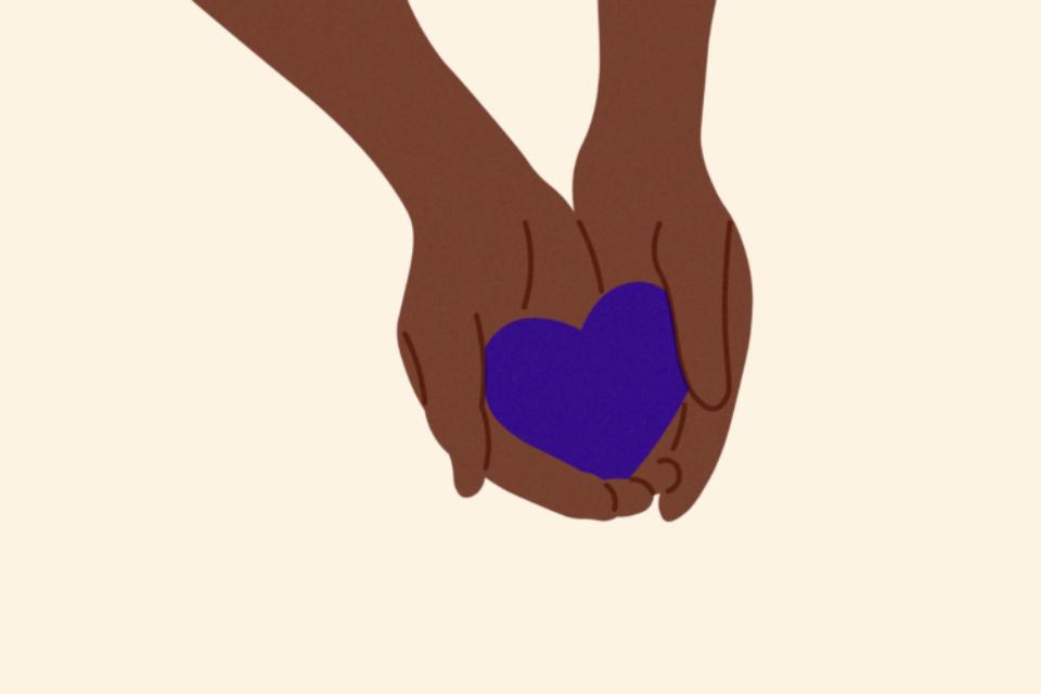 Hands holding a purple heart.