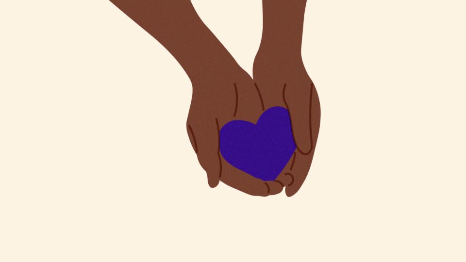 Hands holding a purple heart.