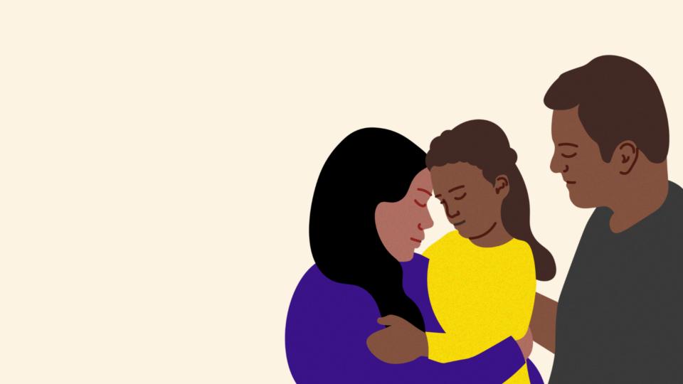 Two parents are holding their daughter in their arms. She is around six years old. They are caring for her.