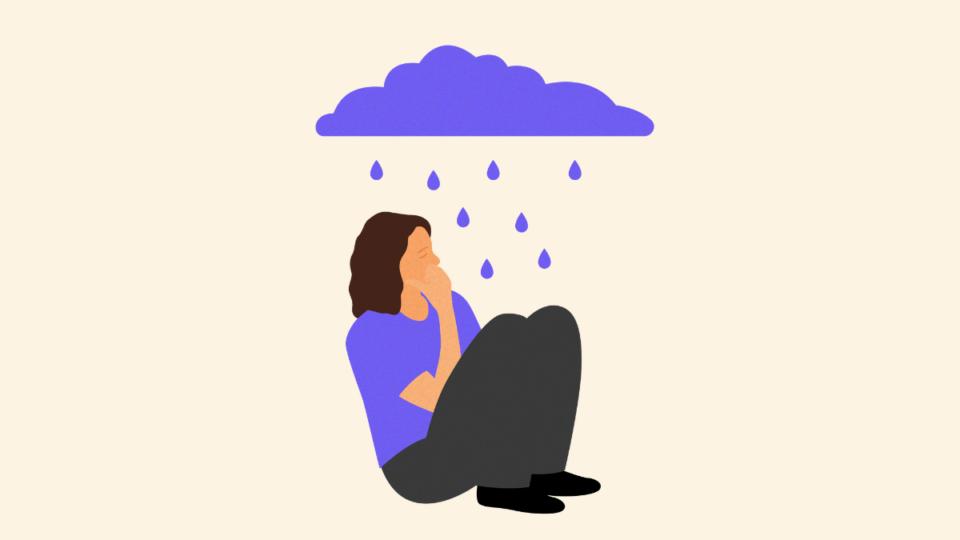 Lady sitting on the floor with her hand to her face. There is a cloud above her and rain falling on her.
